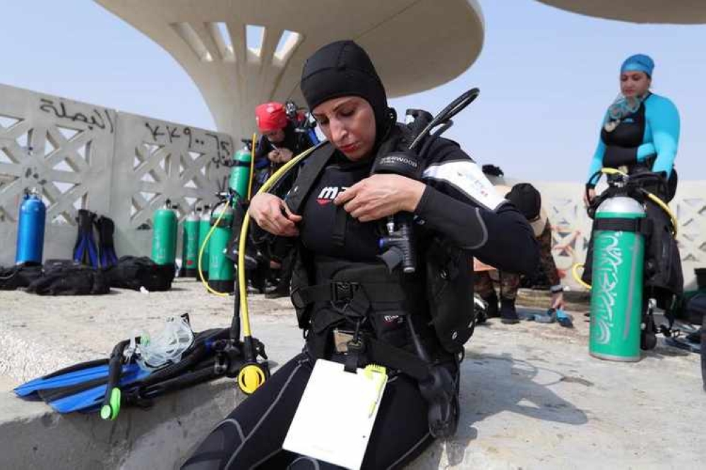 Maryam Al-Muallim, a Saudi female divemaster wears her diving equipment at Half Moon Beach open-water dive site in Dhahran, Saudi Arabia, on Sept. 15, 2018. — Reuters