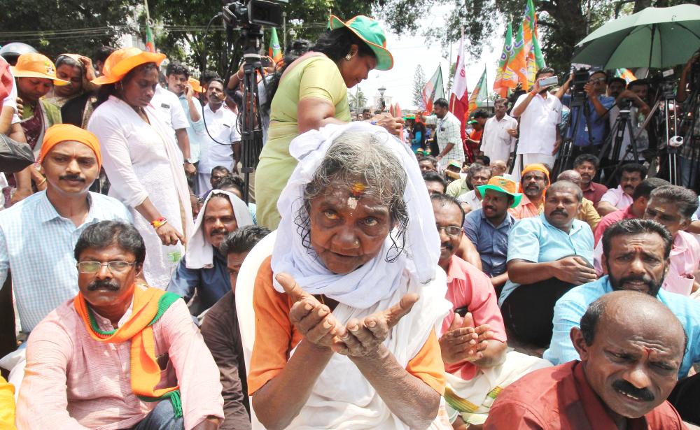 


Indian Hindu devotees take part in a protest against a Supreme Court verdict revoking a ban on women’s entry to a Hindu temple in Thiruvananthapuram in southern Kerala state on Monday. — AFP