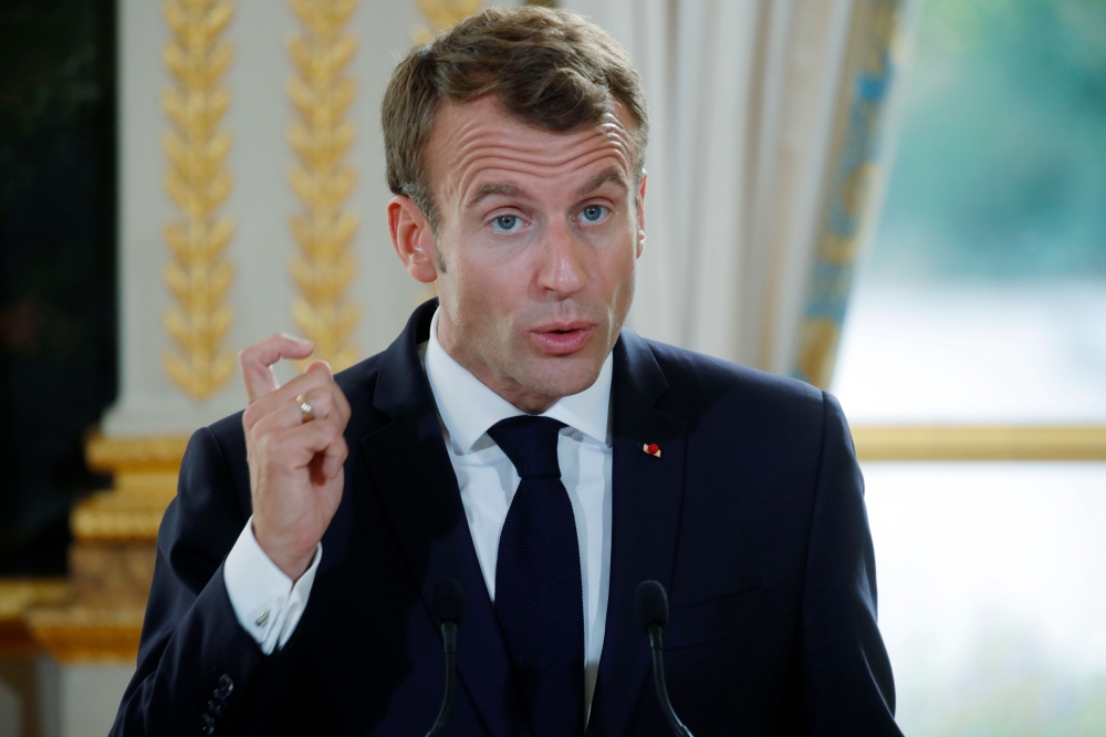 French President Emmanuel Macron speaks during a press conference with South Korean president, not seen, at the Elysee Palace in Paris on Monday. — AFP