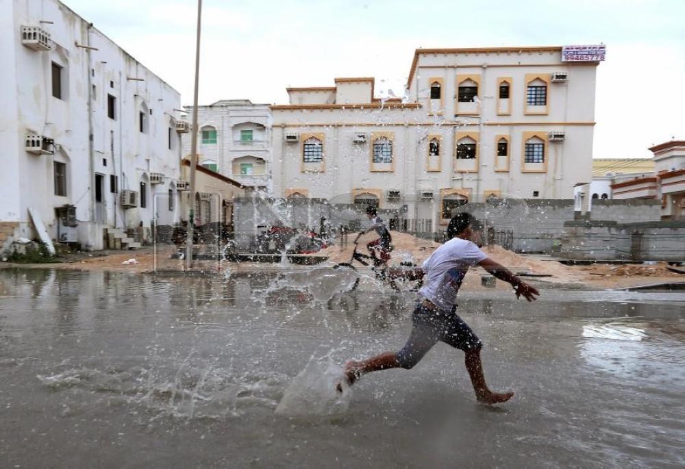 


Children from a local neighborhood play in a roadside puddle accumulated from rain brought by Cyclone Luban in Salalah, Oman. — Reuters