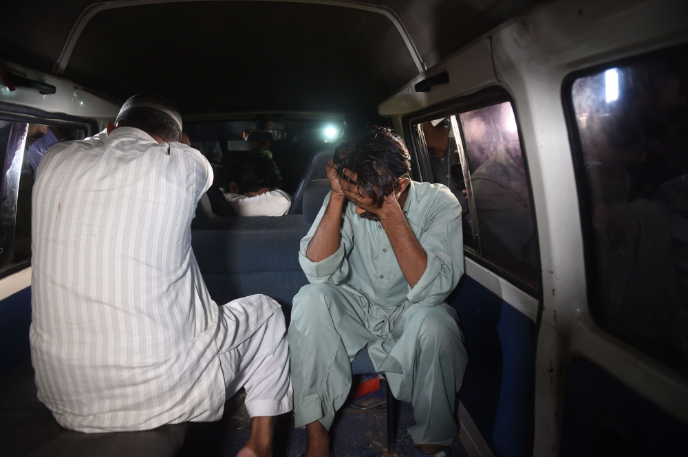 Relatives cover their faces as they arrive at Kot Lakhpat jail to receive the body of Imran Ali, who was executed after being convicted of raping and murdering a six-year-old girl, in Lahore, Pakistan, on Wednesday. — AFP