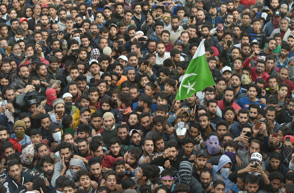 Kashmiri Muslims shout pro-freedom slogans during a funeral procession of a top militant commander Mehrajuddin Bangroo in downtown Srinagar on Wednesday. — AFP