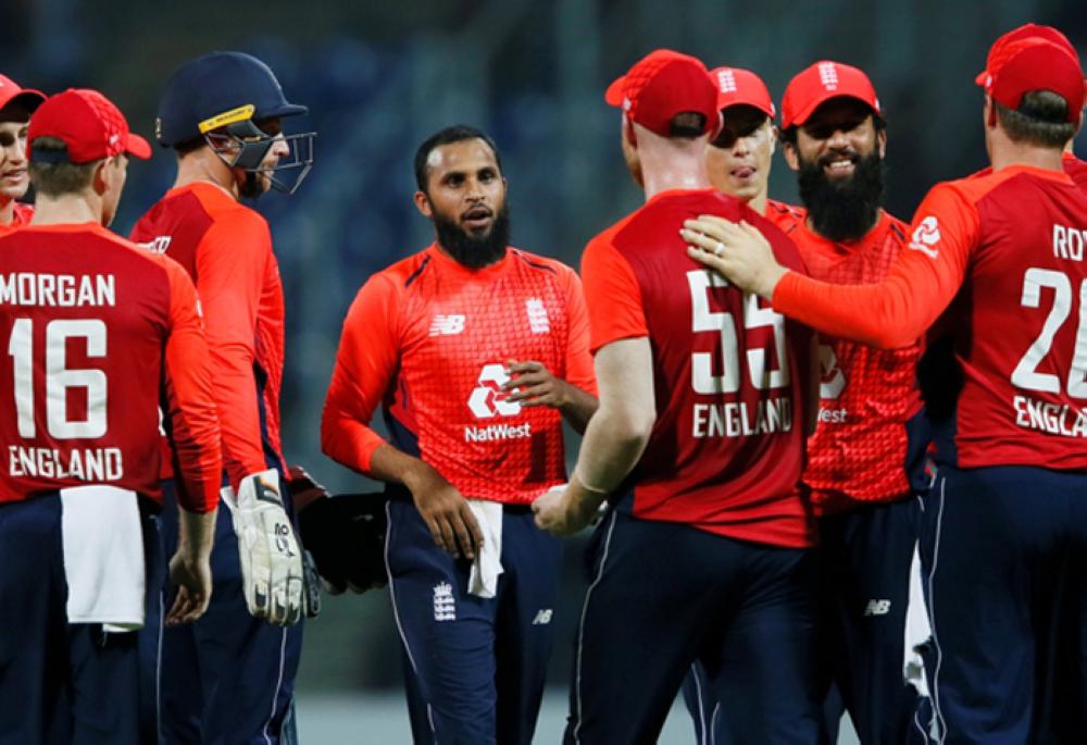 England's Adil Rashid (C) celebrates with his teammates after taking the wicket of Sri Lanka's Thisara Perera (not pictured). — Reuters