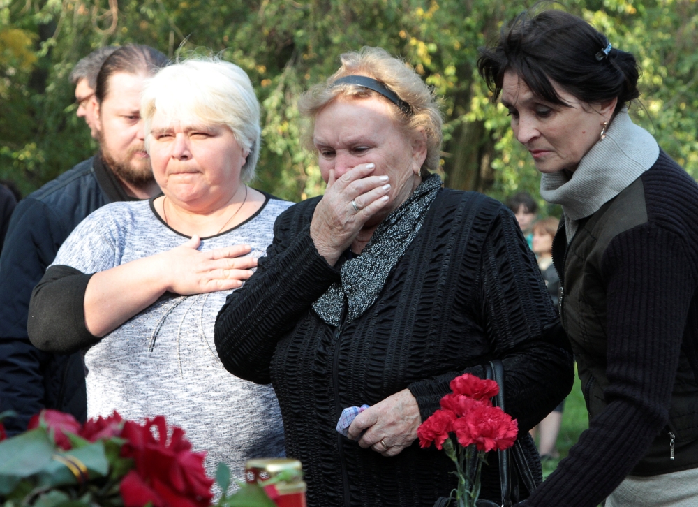 People gather at a makeshift memorial near the scene of a recent attack on a local college in the city of Kerch, Crimea, on Thursday. — Reuters