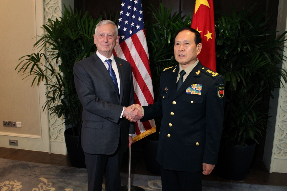 US Defense Secretary Jim Mattis shakes hands with his Chinese counterpart General Wei Fenghe during a meeting on the sidelines of the Association of Southeast Asian Nations (ASEAN) security summit in Singapore on Thursday. — AFP