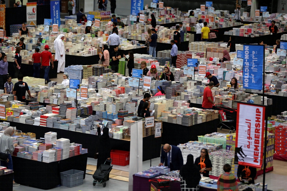 Visitors read books at the Big Bad Wolf Book Sale, which calls itself the world’s biggest, hosted for the first time by Dubai, on Wednesday. — Reuters