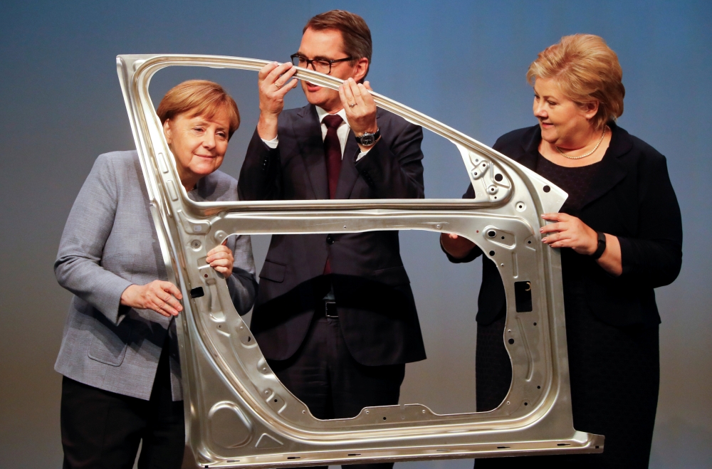 File photo shows German Chancellor Angela Merkel, Svein Richard Brandtzaeg, president and chief executive Officer of Rolled Products and Norwegian Prime Minister Erna Solberg are seen during the official opening of a production line for the car industry at a branch of Norway's Hydro aluminum company in Grevenbroich, Germany. — Reuters