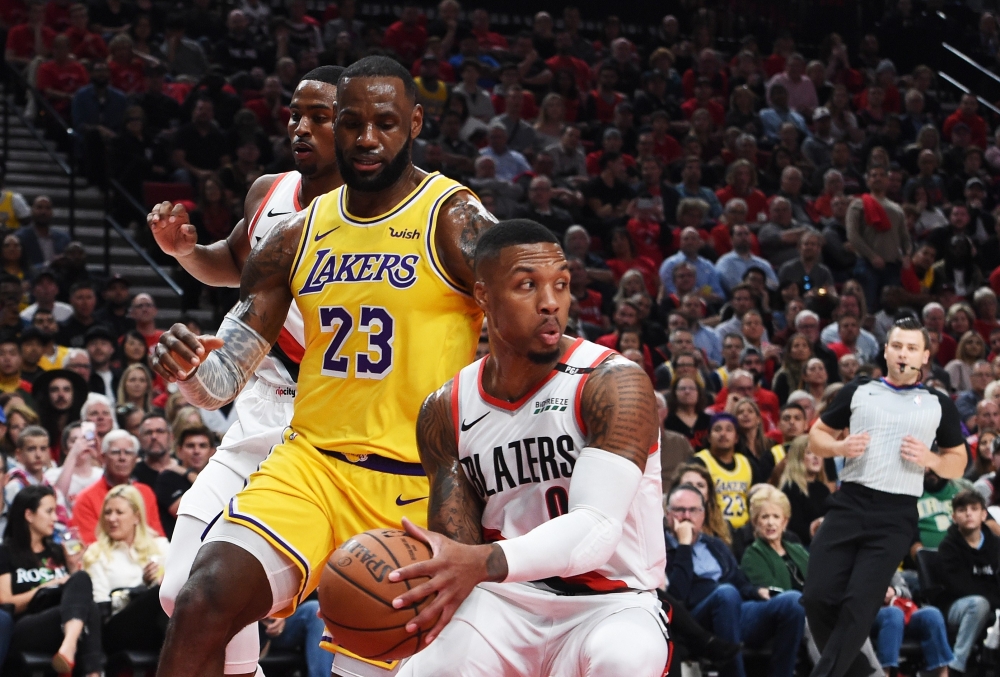 Damian Lillard No. 0 of the Portland Trail Blazers steals from LeBron James No. 23 of the Los Angeles Lakers in the first quarter of their game at Moda Center on Thursday in Portland, Oregon. — AFP