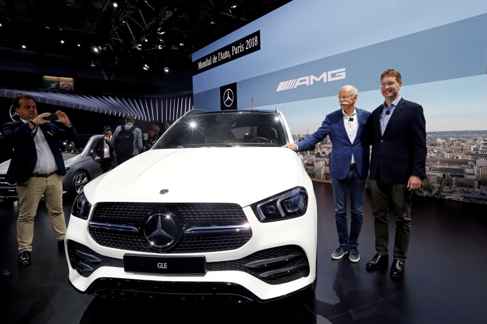 Dieter Zetsche, chairman of the board of management of Daimler AG, and Ola Kallenius, member of the board of management of Daimler AG, present the Mercedes GLE during a press conference on the first press day of the Paris auto show, in Paris, France, recently. — Reuters