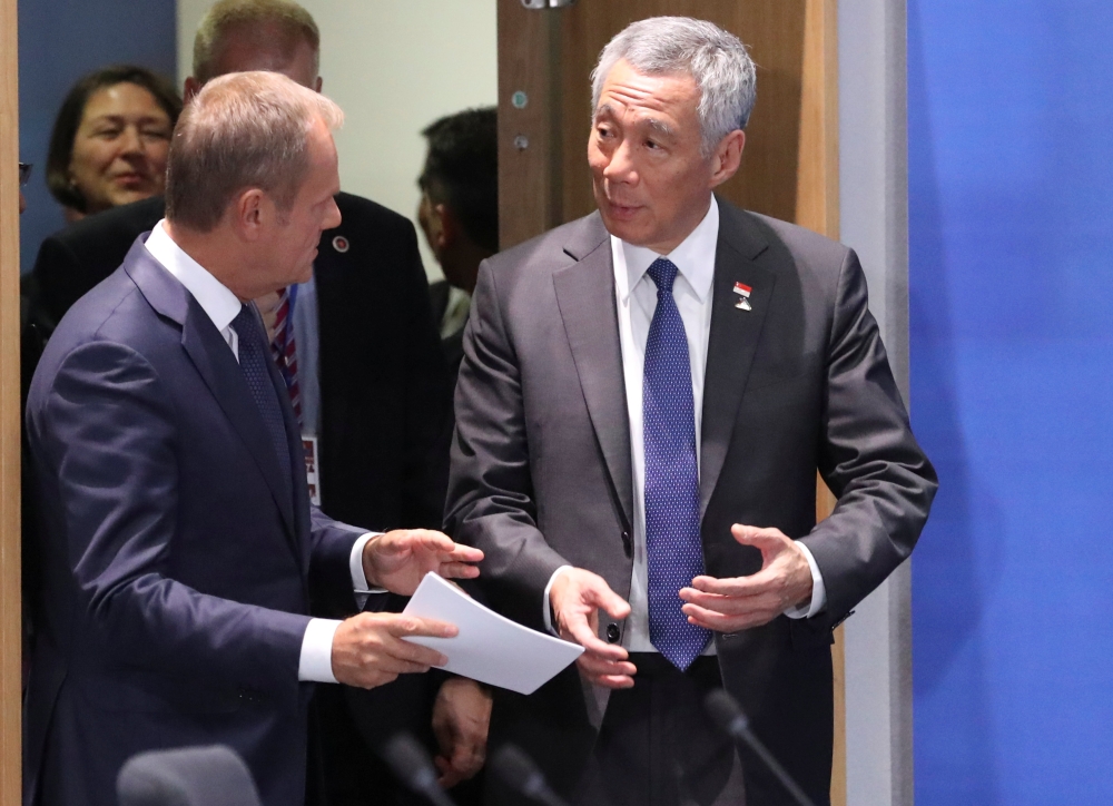 European Council President Donald Tusk and Singapore's Prime Minister Lee Hsien Loong attend the EU-ASEAN meeting on the sidelines of the EU-ASEM summit in Brussels, Belgium, on Friday. — Reuters