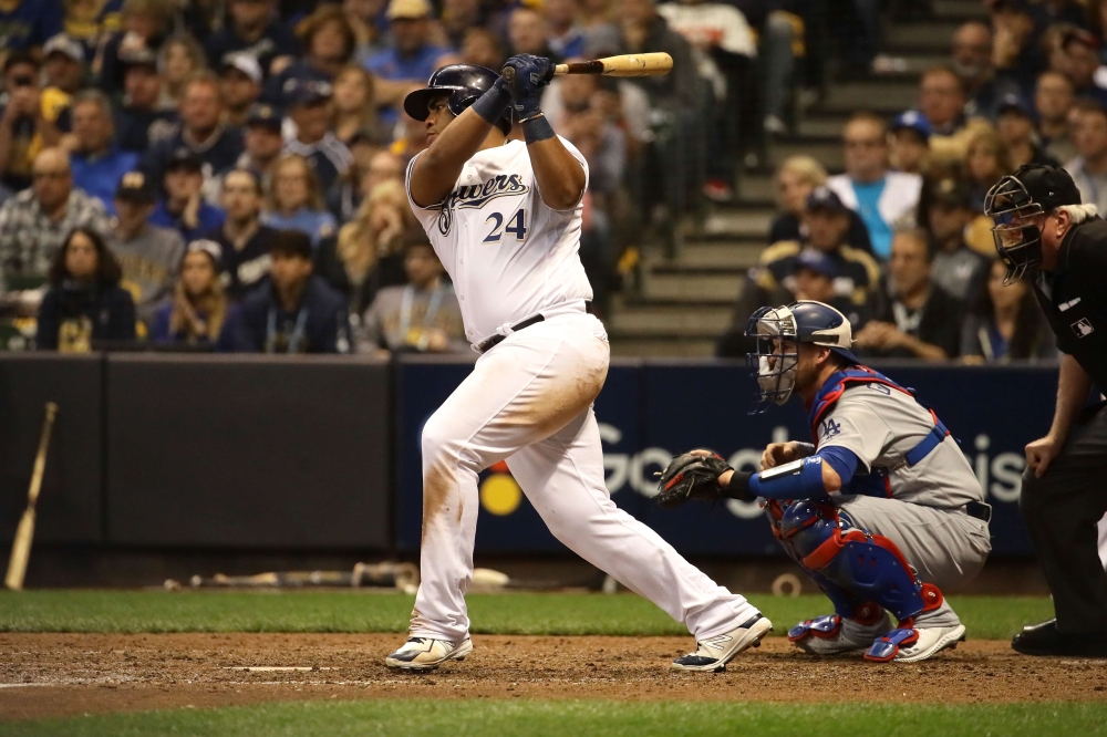 


Jesus Aguilar of the Milwaukee Brewers hits an RBI single against Rich Hill of the Los Angeles Dodgers during Game 6 of the National League Championship Series at Miller Park in Milwaukee Friday. — AFP 