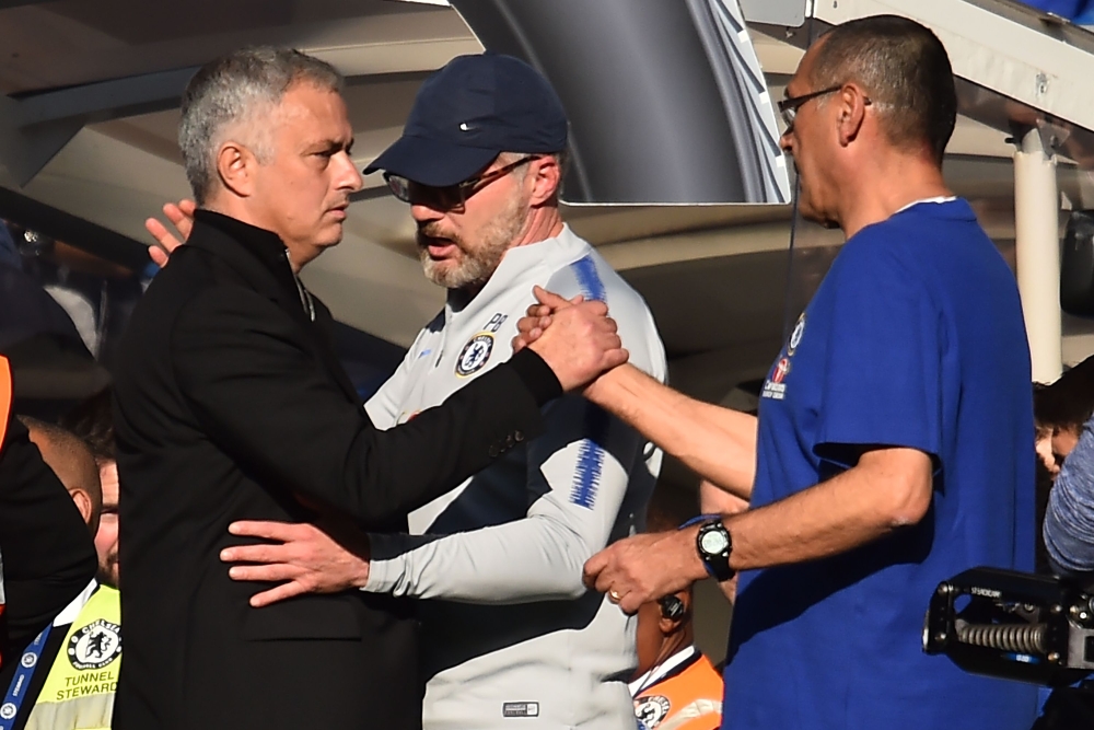 


Manchester United’s manager Jose Mourinho (L) shakes hands with Chelsea’s head coach Maurizio Sarri (R) as Chelsea’s fitness coach Paolo Bertelli (C) stands by after their English Premier League football match at Stamford Bridge in London Saturday. — AFP