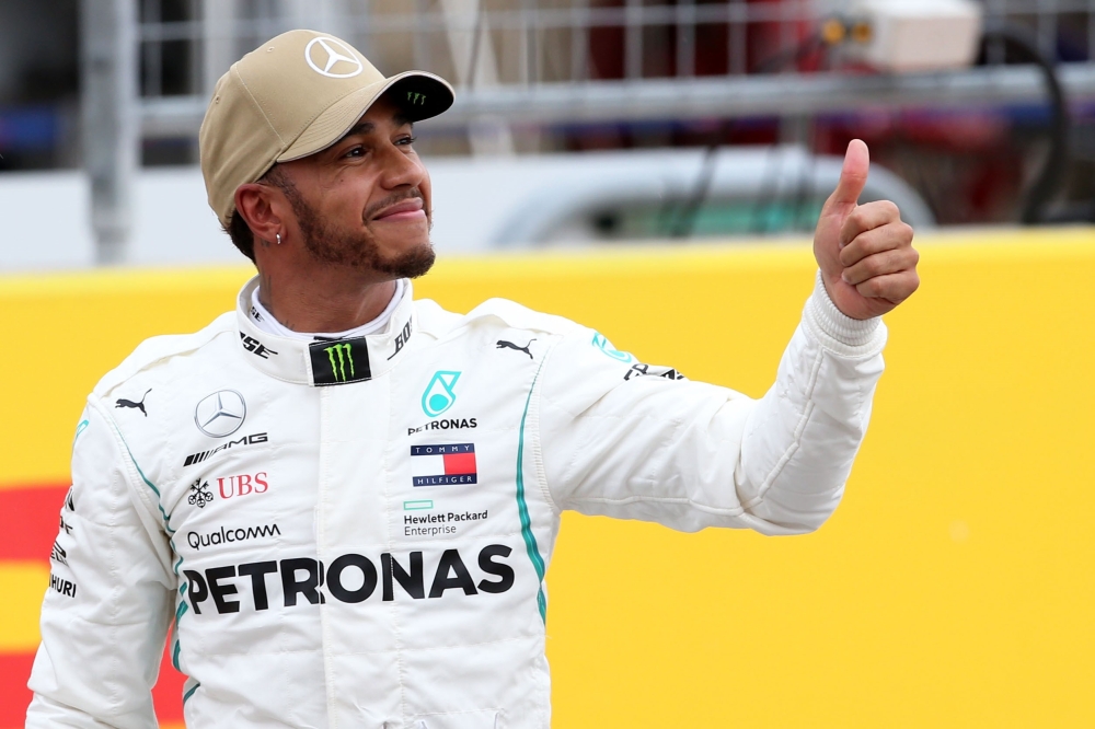 


Pole position winner Lewis Hamilton of Great Britain and Mercedes GP celebrates in parc ferme during qualifying for the US Formula One Grand Prix in Austin Saturday. — AFP 