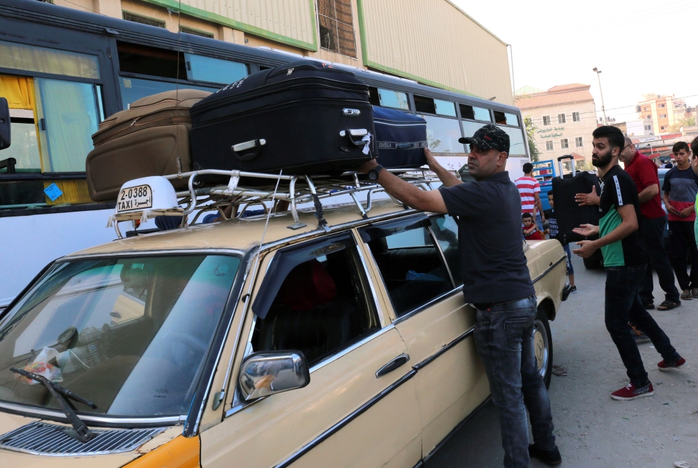 


Palestinians load bags atop a taxi before travelling to Egypt through the Rafah border crossing in the southern Gaza Strip. Since mid-May, after five long years in which the frontier was largely closed, Egyptian authorities have opened the crossing several days a week. — AFP