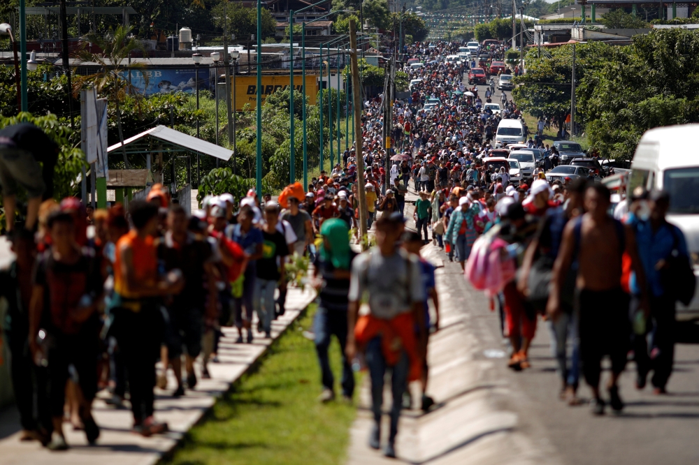 Central American migrants walk along the highway near the border with Guatemala, as they continue their journey trying to reach the US, in Tapachula, Mexico, on Sunday. — Reuters