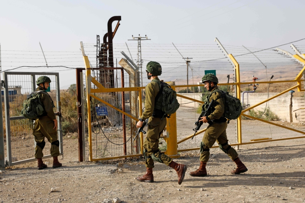 


Israeli soldiers patrol the border fence in Naharayim also known by Jordanians as Baqura in the Jordan valley in Northern Israel, Sunday. — AFP
