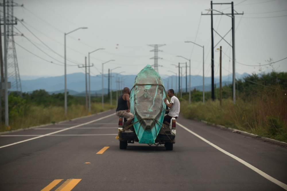 Men transport a boat on a truck in Teacapan, Sinaloa state, Mexico, on Monday, before the arrival of Hurricane Willa. — AFP
