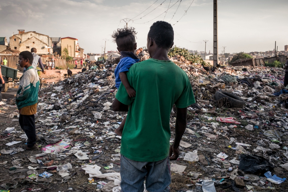 


A man and a child stand in front of a garbage heap in Manjakaray, one of the poorest, most unhealthy and insecure districts of Malagasy capital, Antananarivo, during the presidential campaign.  With a poverty rate of 76.2 percent, Madagascar, a former French colony, is one of the world’s poorest countries according to World Bank data. — AFP