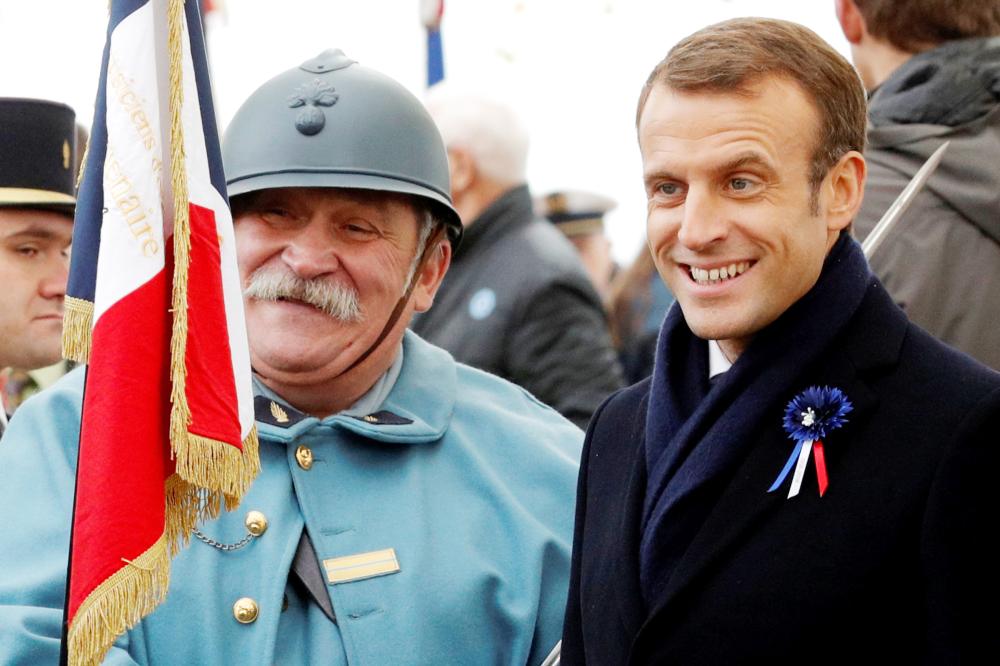 


French President Emmanuel Macron poses with history enthusiasts, dressed with vintage army uniforms as Poilu (French soldier in World War I), after a ceremony at the Memorial to the Battle of Morhange, Eastern France, on Monday, as part of a World War I commemoration tour. — Reuters