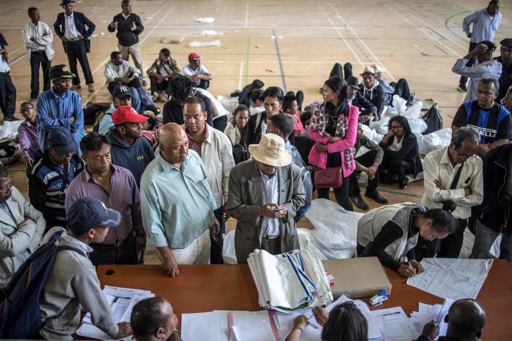 Delegates are seen handing over election reports at the Stade Municipal de Mahamasina Antananarivo on Thursday where the national tallying center has been set up, at the end of the first round of the presidential elections. — AFP