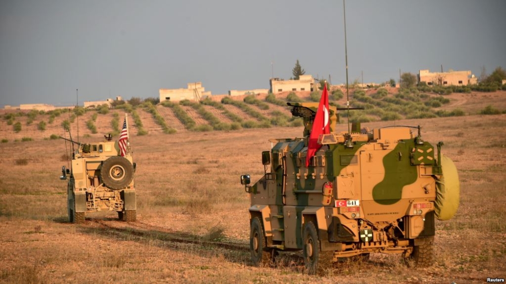 


Turkish and US troops are pictured during a joint patrol in Manbij area, northern Syria, last week. — Reuters