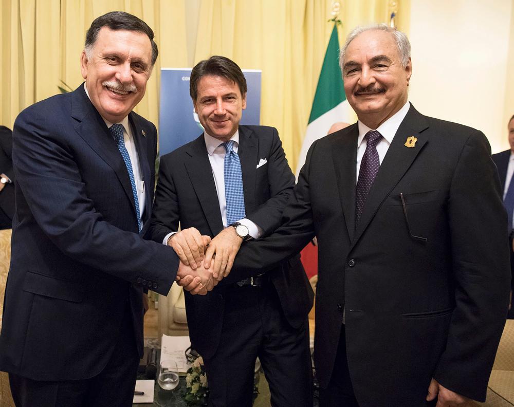 Italian Prime Minister Giuseppe Conte (center) poses with head of the UN-backed unity government in Tripoli, Prime Minister Fayez Al-Sarraj (left) and Libya Chief of Staff, Marshall Khalifa Haftar on the sidelines of an international conference on Libya in Palermo. — AFP