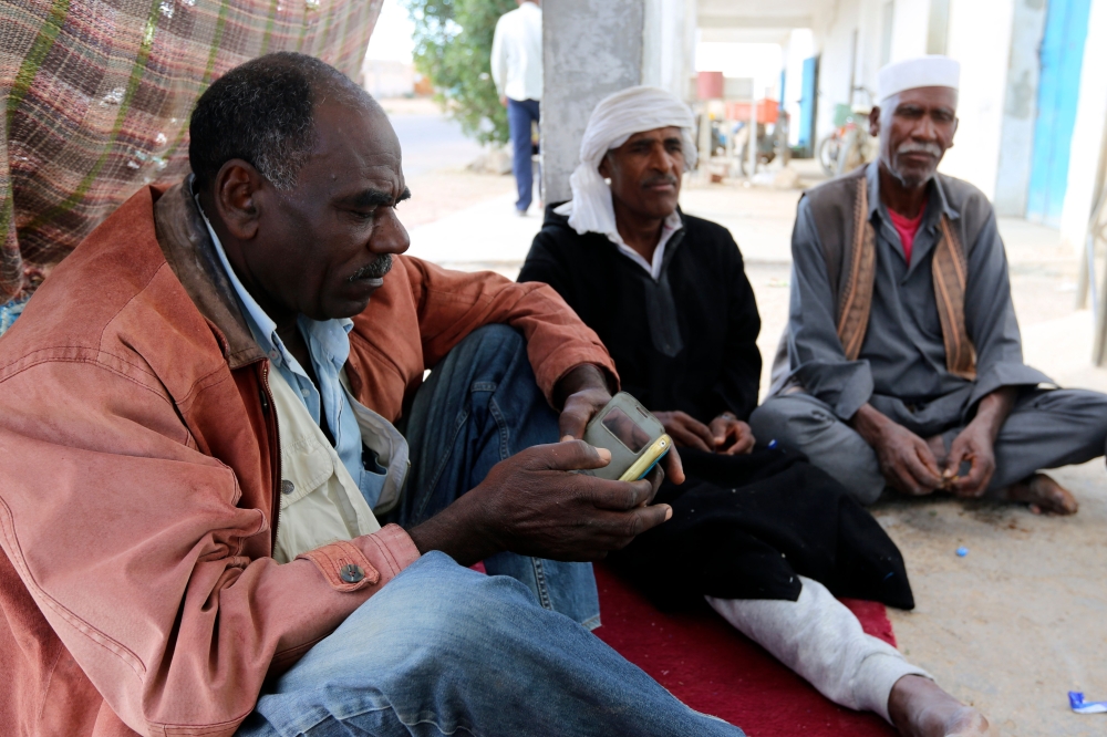 Tunisian men gather in Gosba, near the southeastern town of Medenine. Black Tunisians, including some descended from slaves, make up a minority that is barely visible in the north African country. Many hope for greater equality after a law was passed earlier this year criminalizing all forms of racism. — AFP