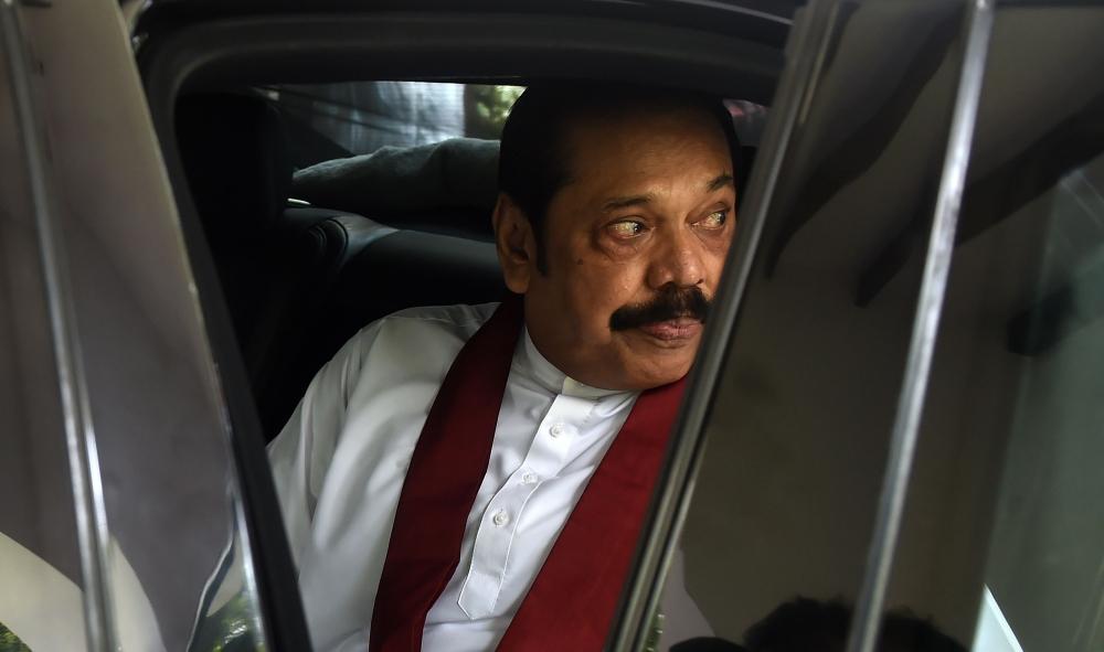 Sri Lanka's former president Mahinda Rajapaksa leaves the official residence in Colombo on November 11, 2018. — AFP