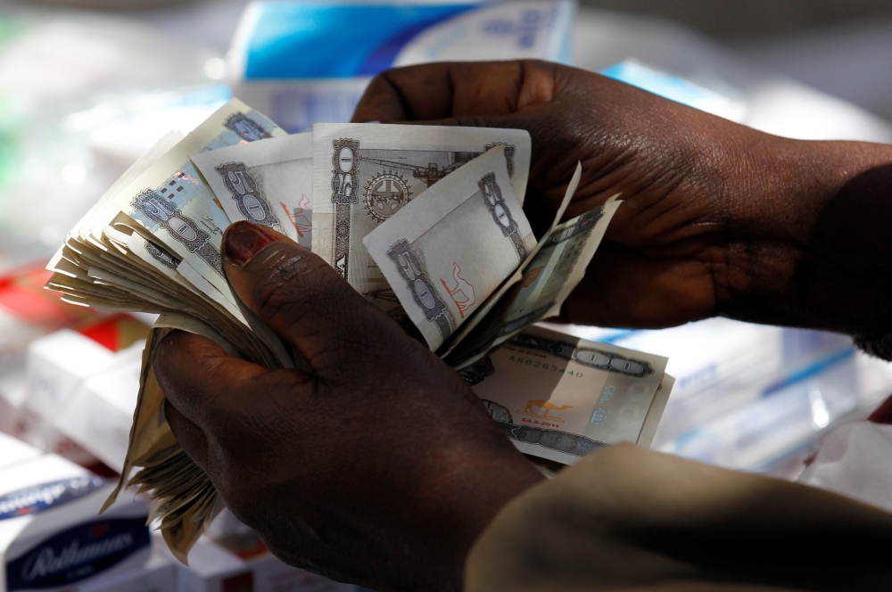 A vendor counts Eritrean “Nakfa” bank notes in downtown Asmara, Eritrea in this photo taken on Feb. 21, 2016. — Reuters