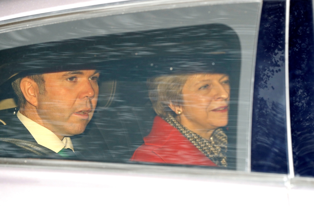 British Prime Minister Theresa May, together with her Chief of Staff Gavin Barwell, leaves the LBC radio studios in central London on Friday. — Reuters