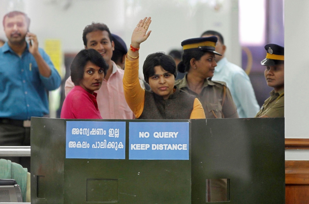 Trupti Desai, a women’s rights activist, waves from inside the Cochin International Airport at Kochi, India, on Friday. — Reuters