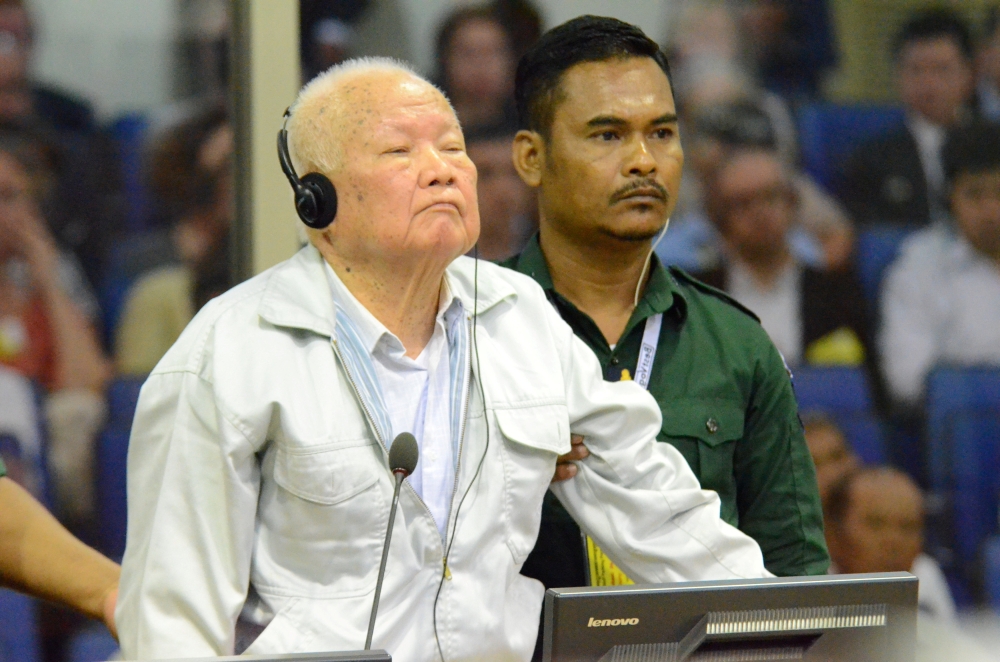 Former Khmer Rouge head of state Khieu Samphan stands inside a dock at the courtroom of the Extraordinary Chambers in the Courts of Cambodia (ECCC) as he awaits a verdict, on the outskirts of Phnom Penh, Cambodia, on Friday. — Reuters