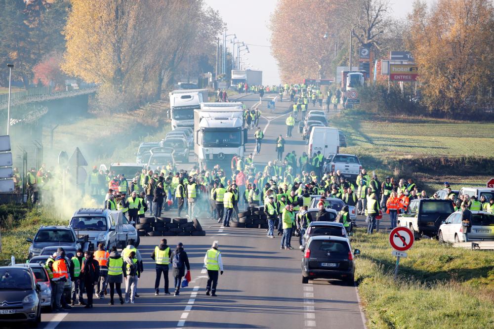 


People wearing yellow vests, a symbol of a French drivers’ nationwide protest against higher fuel prices, block the Paris-Brussels motorway in Haulchin, France, Saturday. — Reuters