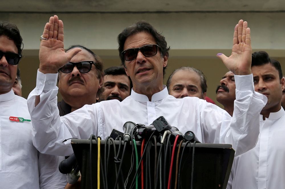 Pakistani Prime Minister Imran Khan speaks to members of media after casting his vote at a polling station during the general election in Islamabad in this July 25, 2018 file photo. — Reuters