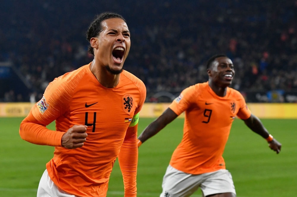 Netherlands' defender Virgil van Dijk (L) celebrates scoring the 2-2 with Dutch forward Quincy Promes during the UEFA Nations League football match against Germany in Gelsenkirchen on Monday. — AFP