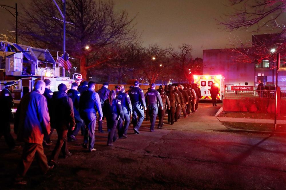 


The body of slain Chicago police officer Samuel Jimenez at the shooting at the Mercy Hospital is being escorted to the Medical Examiner Office in Chicago, Illinois, on Monday. — AFP