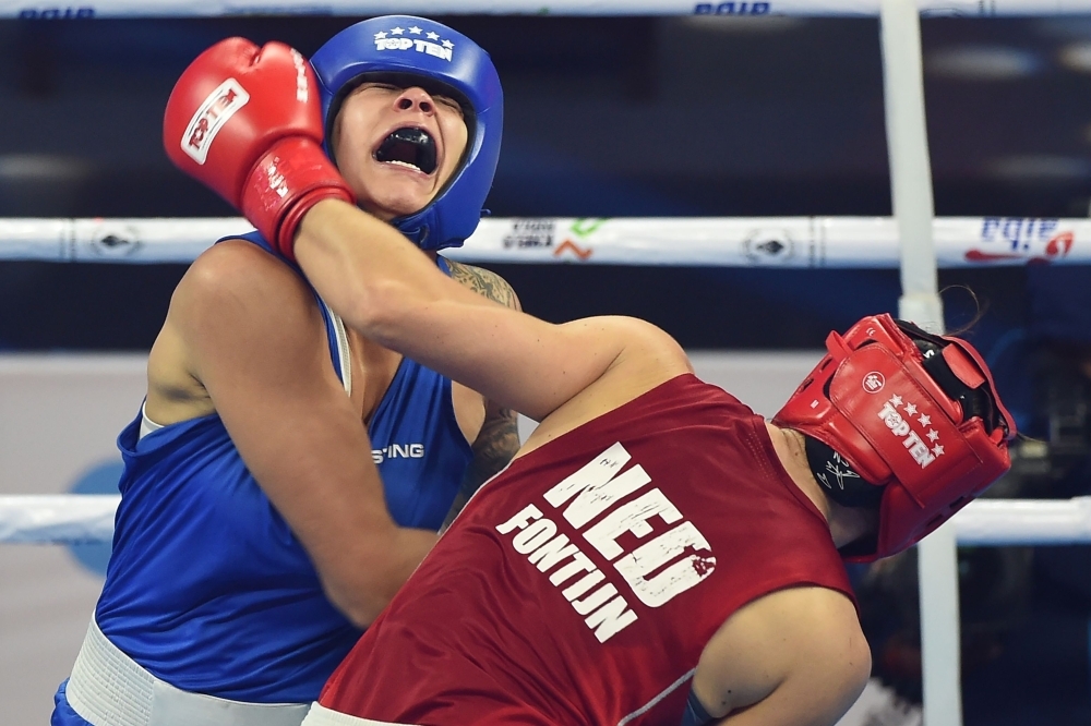 Tammara Thibeault of Canada (in blue) and Nouchka Mireille Fontijn of Netherlands (in red) compete during their 75 kg category quarterfinal fight at the 2018 AIBA Women's World Boxing Championships in New Delhi on Tuesday. — AFP