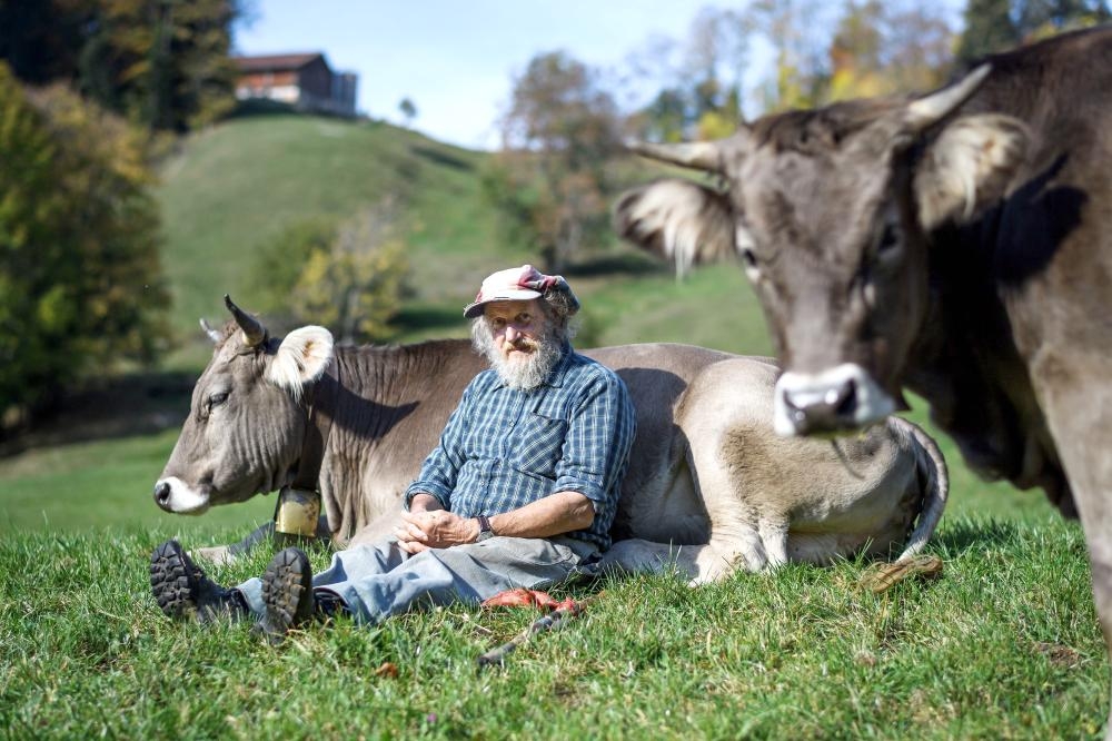 Swiss farmer Armin Capaul poses with one of his cows ahead of the nationwide vote on his initiative on cow horns, near Perrefitte, northern Switzerland, in this Oct. 16, 2018 file photo. — AFP


 Capaul launched and collected more that 100,000 signatures for an initiative to offer monetary assistance to owners who don't dehorn their livestock. Swiss citizen will vote on the issue on November 25, 2018.  - 
 / AFP / Fabrice COFFRINI