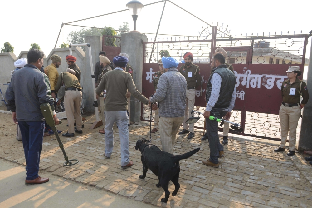 Indian Punjab Police personnel inspect Nirankari Mission followers entering the Nirankari Satsang Bhawan in Rajasansi village on the outskirts of Amritsar in this Nov. 19, 2018 file photo. — AFP