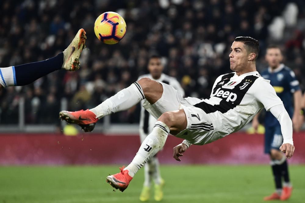 Juventus' Portuguese forward Cristiano Ronaldo does an overhead kick during the Italian Serie A football match Juventus vs Spal 2013 on November 24, 2018 at the Juventus stadium in Turin. — AFP