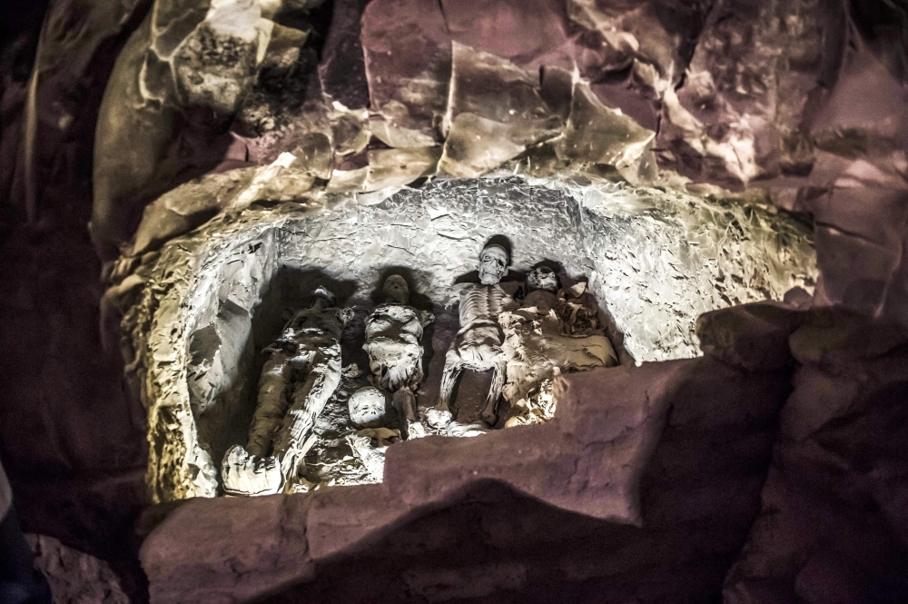 A group of mummies stacked together at the site of Tomb TT28.