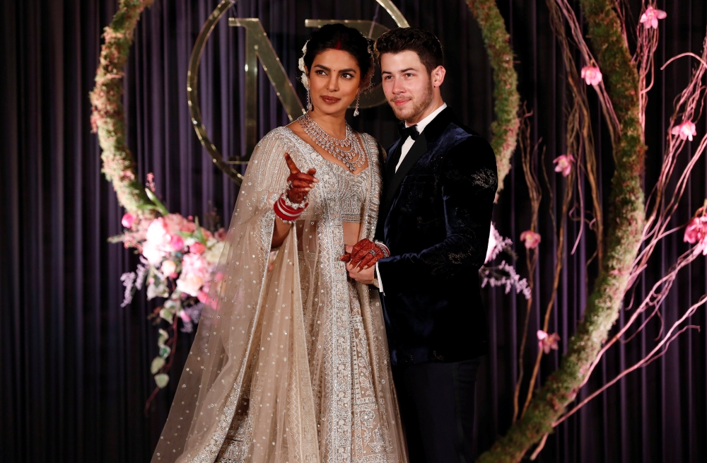 Bollywood actress Priyanka Chopra and her husband singer Nick Jonas pose during a photo opportunity at their wedding reception in New Delhi. — Reuters