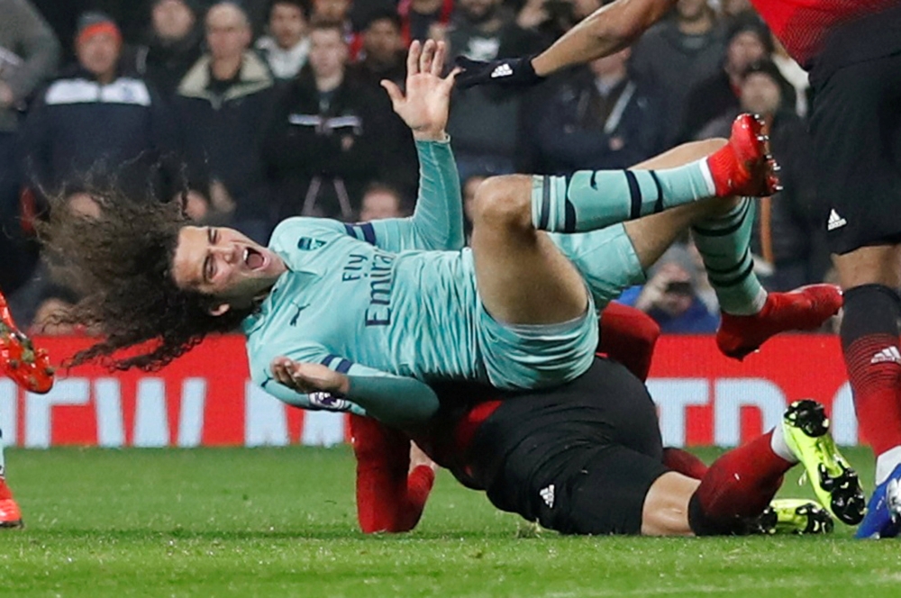 Arsenal's Matteo Guendouzi is fouled by Manchester United's Marcos Rojo during the English Premier League clash at Old Trafford, Manchester, Britain, on Wednesday. — Reuters