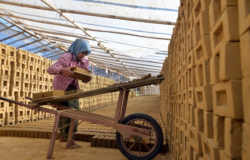 This photo taken on Wednesday shows Myanmar woman working in a brick factory in Naypyidaw. —  AFP