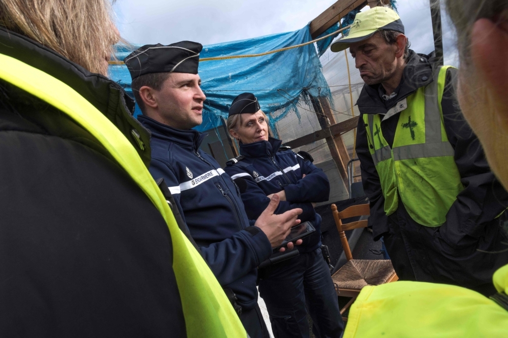 French Gendarme speak with members of the 