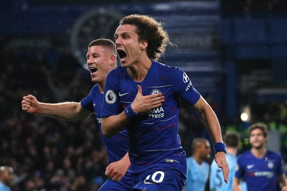 Chelsea’s defender David Luiz (R) celebrates with Ross Barkley after scoring their second goal during the English Premier League football match against Manchester City at Stamford Bridge in London Saturday. — AFP