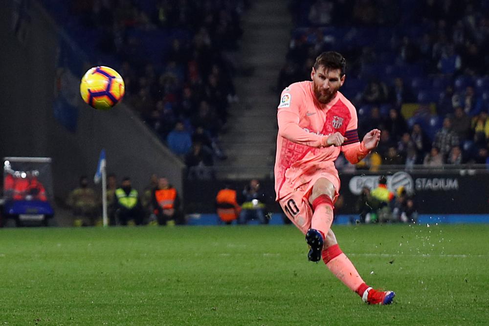 Barcelona’s Lionel Messi scores their fourth goal against Espanyol during their La Liga match at RCDE Stadium, Barcelona, Saturday. — Reuters