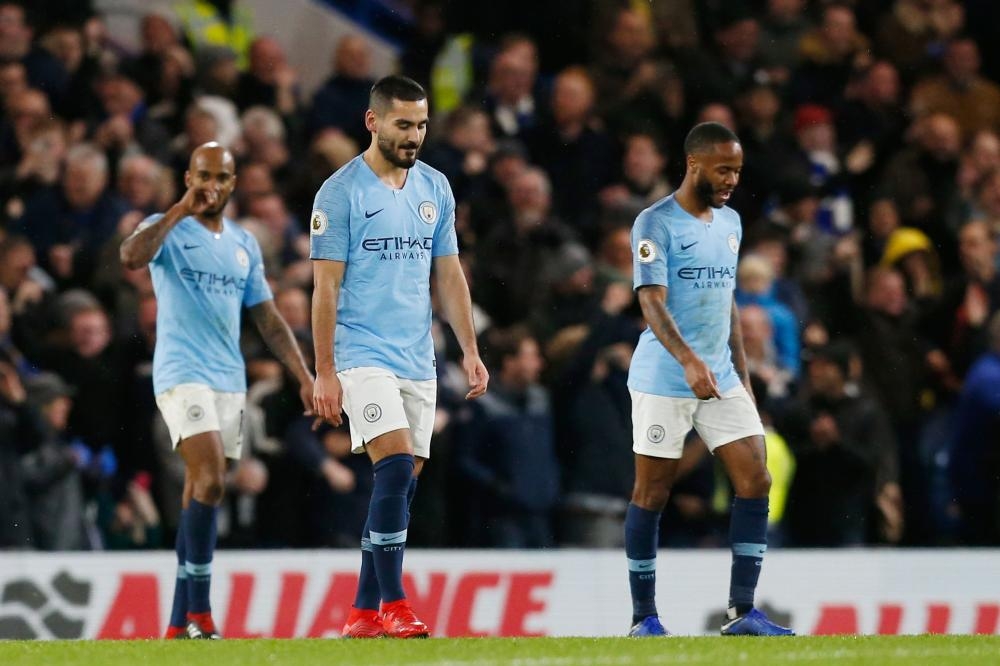 Manchester City's Fabian Delph (L), Ilkay Gundogan (C) and Raheem Sterling react after Chelsea scored its second goal during their English Premier League football match at Stamford Bridge in London Saturday. — AFP