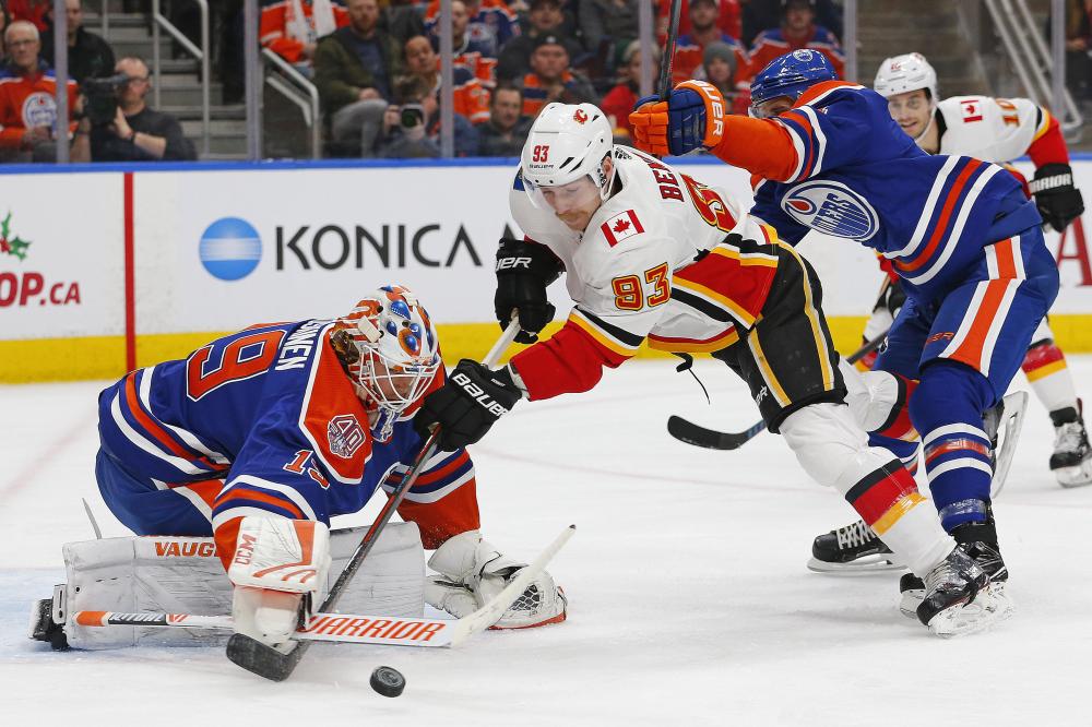 Edmonton Oilers’ goaltender Mikko Koskinen makes a save on Calgary Flames’ forward Sam Bennett during their NHL game at Rogers Place in Edmonton Sunday. — Reuters