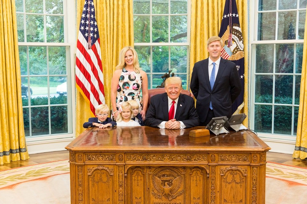 US President Donald Trump and Vice President’s Chief of Staff Nick Ayers, right, and his wife Jamie Floyd with their children pose for pictures in the Oval Office at the White House in this social media photo released by Vice President Mike Pence’s office in Washington in this July 28, 2017 file photo. — Reuters